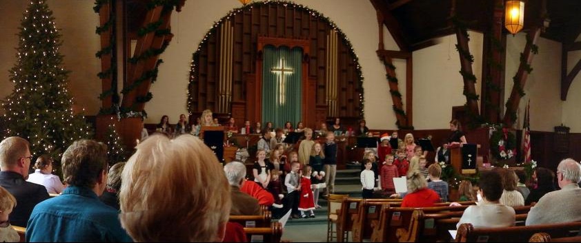 wide view of Sunday church worship with Christmas pageant performed by children